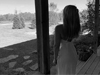 Woman looking at view from front porch.