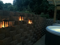 Candle lit lanterns on the brick wall