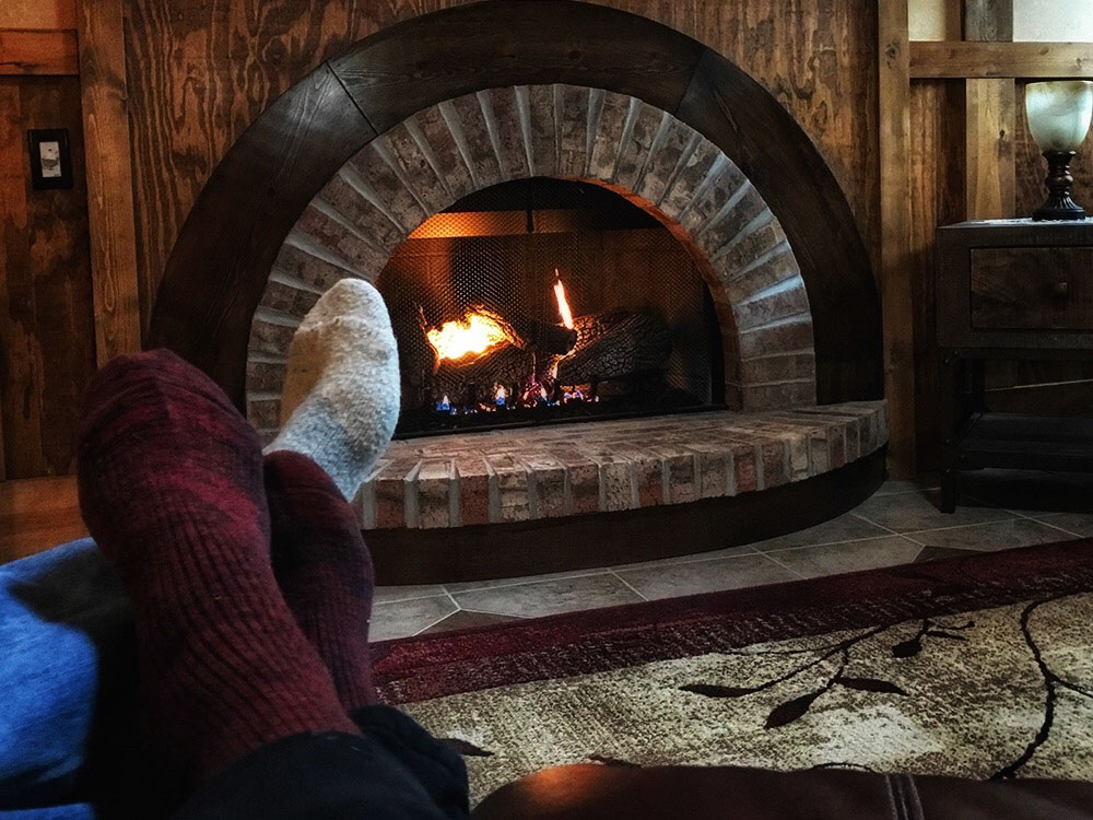 Image of cozy socks in front of the Hollow Fireplace